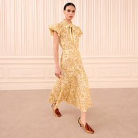 Riada Concept Ulla Johnson Clarisse high-waisted cotton poplin trumpet midi skirt in a pale yellow print - styled model view