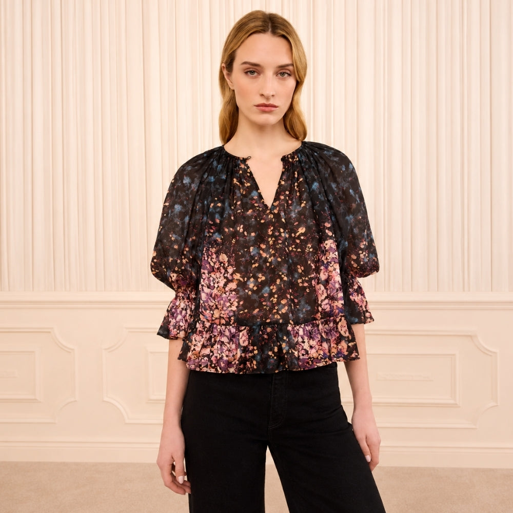 Riada Concept Ulla Johnson Elise silk jacquard blouse in a black floral bouquet print, with ruffles at the sleeves and hem - styled model