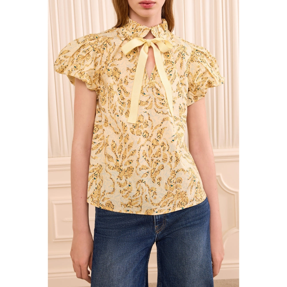 Riada Concept Ulla Johnson Estela cotton poplin top in a pale yellow print, with bubble sleeves and a ruffled tie neck - front close-up