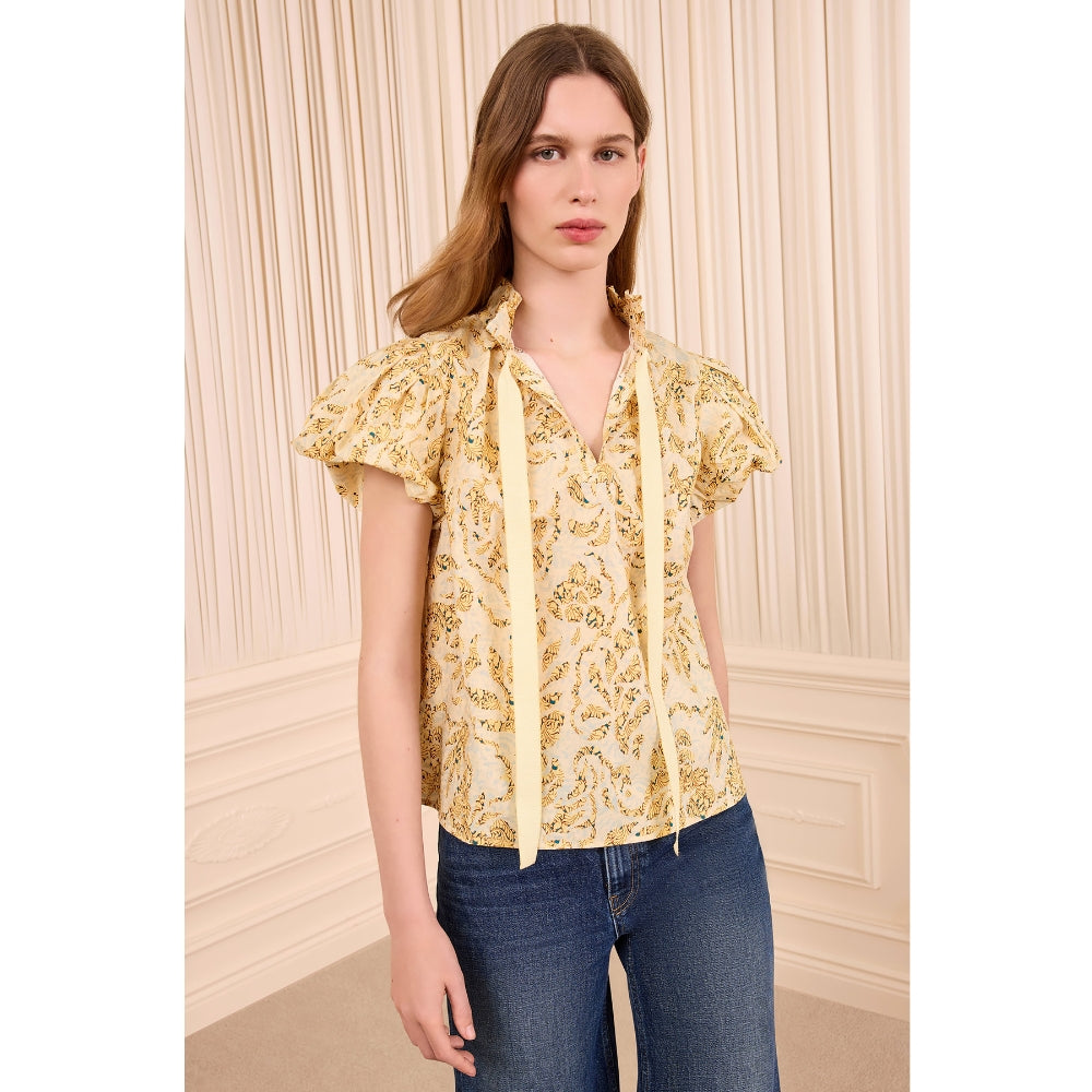 Riada Concept Ulla Johnson Estela cotton poplin top in a pale yellow print, with bubble sleeves and a ruffled tie neck - front view