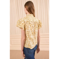 Riada Concept Ulla Johnson Estela cotton poplin top in a pale yellow print, with bubble sleeves and a ruffled tie neck - back view