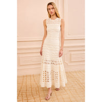 Shop Ulla Johnson Lakshmi in Cowrie, a cream eyelet knit maxi dress with scalloped ruffles, close fit and full flared hem at Riada Australia.