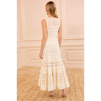 Shop Ulla Johnson Lakshmi in Cowrie, a cream eyelet knit maxi dress with scalloped ruffles, close fit and full flared hem at Riada Australia.