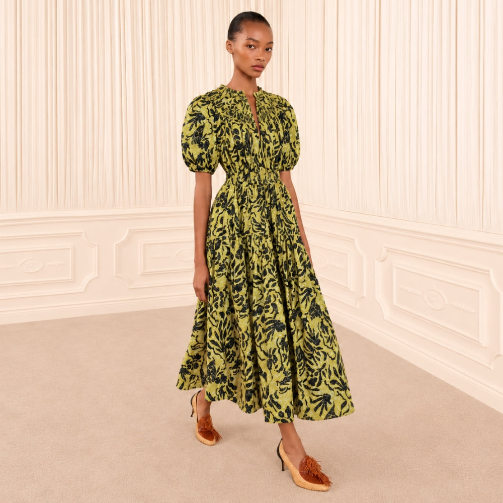 Riada Concept Ulla Johnson Othella cotton poplin midi dress in a chartreuse botanical print, with puff sleeves and pockets - styled model front view