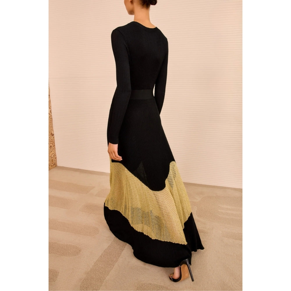 Shop Ulla Johnson Roanne in Gold Noir, a slim rib-knit long dress with shimmering Lurex mesh hem, crew neck and fluid ankle-grazing skirt at Riada.