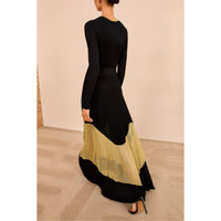 Shop Ulla Johnson Roanne in Gold Noir, a slim rib-knit long dress with shimmering Lurex mesh hem, crew neck and fluid ankle-grazing skirt at Riada.