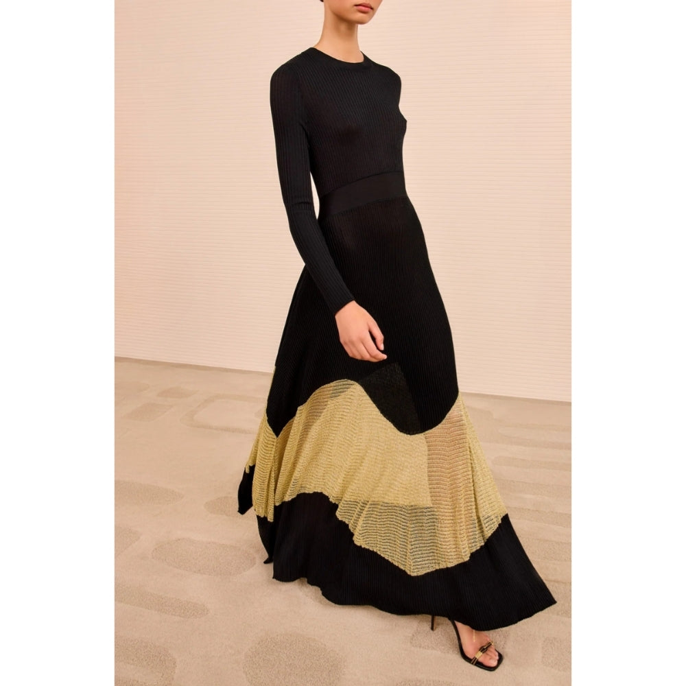 Shop Ulla Johnson Roanne in Gold Noir, a slim rib-knit long dress with shimmering Lurex mesh hem, crew neck and fluid ankle-grazing skirt at Riada.