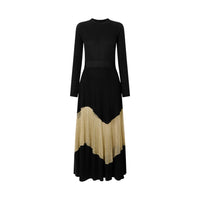 Shop Ulla Johnson Roanne in Gold Noir, a slim rib-knit long dress with shimmering Lurex mesh hem, crew neck and fluid ankle-grazing skirt at Riada.