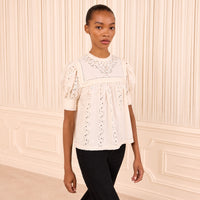 Riada Concept Ulla Johnson Una ivory cotton poplin top with eyelet embroidery, an embroidered yoke and puff sleeves - styled model