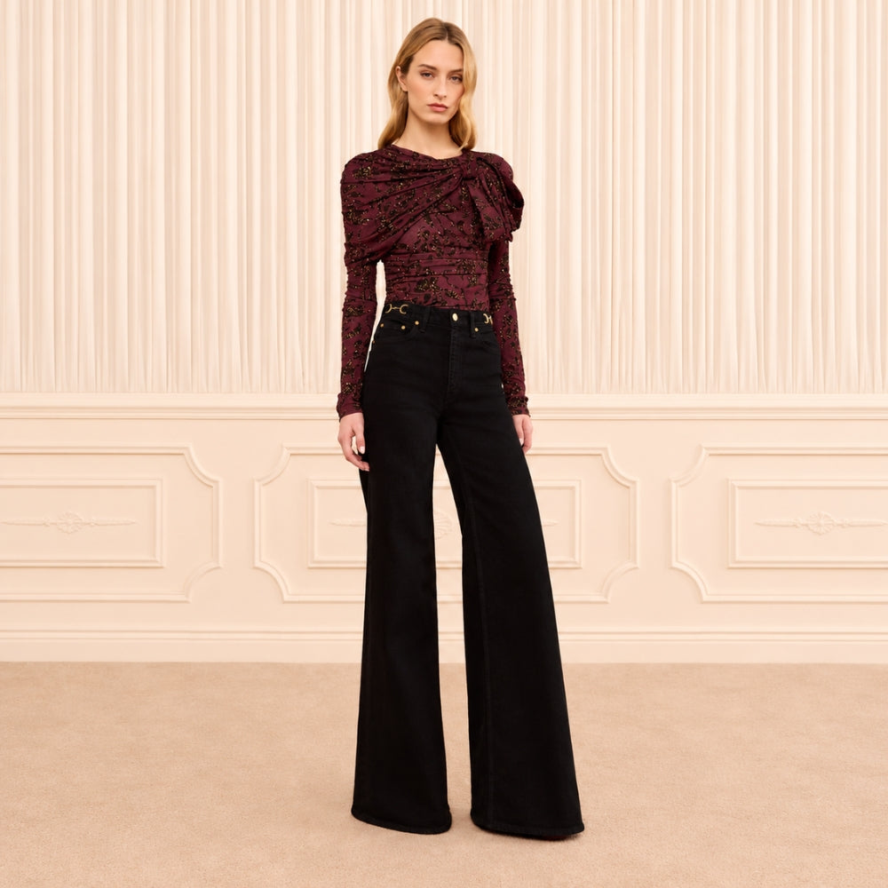 Ulla Johnson Valory high-rise flare jeans in black stretch denim with gold horsebit hardware. Shop at Riada Concept, shipping Australia-wide and worldwide.