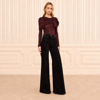 Ulla Johnson Valory high-rise flare jeans in black stretch denim with gold horsebit hardware. Shop at Riada Concept, shipping Australia-wide and worldwide.