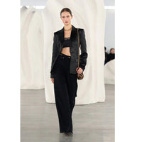 Ulla Johnson Valory high-rise flare jeans in black stretch denim with gold horsebit hardware. Shop at Riada Concept, shipping Australia-wide and worldwide.