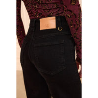 Ulla Johnson Valory high-rise flare jeans in black stretch denim with gold horsebit hardware. Shop at Riada Concept, shipping Australia-wide and worldwide.