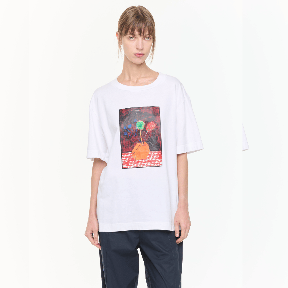 Plan C Vase Print Cotton T-Shirt in Optical White with multicolour floral vase artwork styled on model with relaxed black trousers - cropped front view