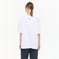 Plan C Vase Print Cotton T-Shirt in Optical White with multicolour floral vase artwork styled on model with relaxed black trousers - back view